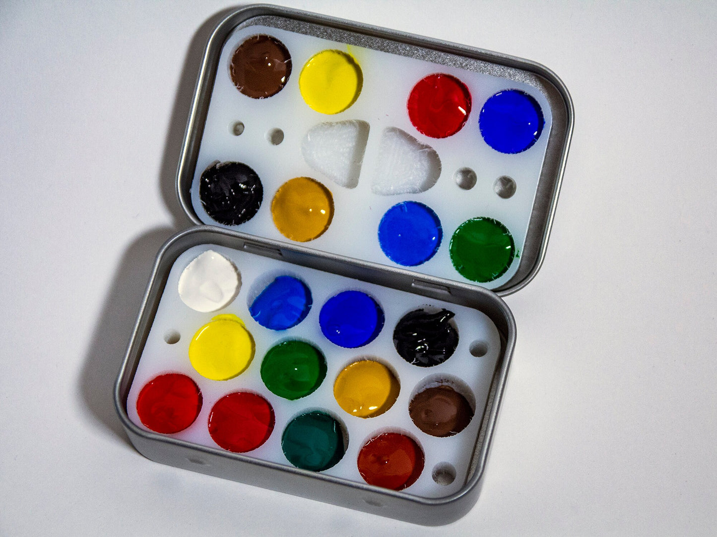 Compact travel-friendly paint palette filled with paint